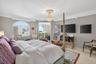 Primary bedroom w/ beautiful views of intracoastal and to balcony and ocean. Motorized window treatments. Chandelier does not convey.