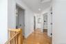 Hallway with light wood-type flooring, recessed lighting, a sink, and baseboards