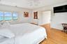 Second Floor Primary Bedroom with crown molding, light wood-style floors, ceiling fan, recessed lighting, and a water view