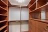 Custom closet system with wood-finish shelving and built-in drawers