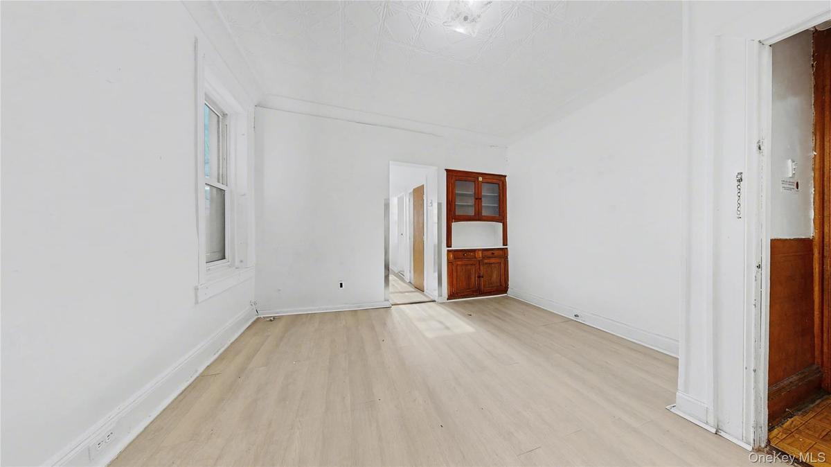 Spare room featuring light wood-type flooring and baseboards