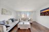 Spacious living area featuring rich wood-finish flooring