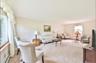 Living room with carpet floors, baseboard heating, and a baseboard radiator