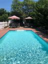 View of swimming pool with a wooden deck and a patio area