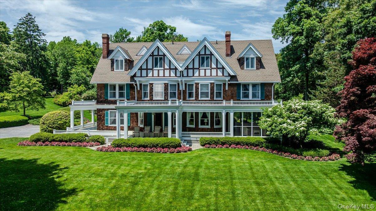 Open porches, gables, 5 fireplaces enveloped by mature plantings and trees