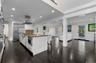 Kitchen with a kitchen breakfast bar, dark stone counters, recessed lighting, appliances with stainless steel finishes, and white cabinets
