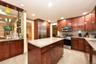 Kitchen featuring tasteful backsplash, appliances with stainless steel finishes, sink, and light stone counters