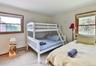 Carpeted bedroom featuring baseboard heating and baseboards