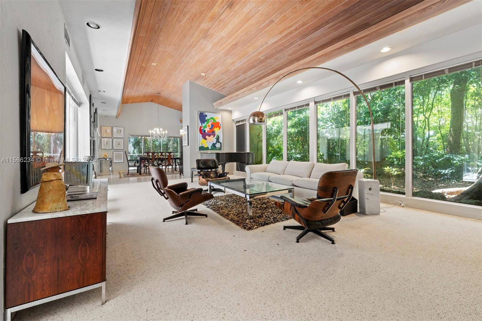 Welcome to your slice of midcentury modern paradise nestled within a lush, verdant oasis.