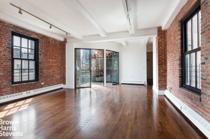 This light filled duplex loft offers a private roof deck with stunning views of the downtown skyline.