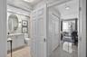 Secondary primary bedroom (guest room) w/ en suite bathroom and closet w/ upgraded door hardware. Emtek crystal door hardware. Bathroom w/ designer wa