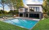 Modern exterior with horizontal siding, large windows & inground pool & spa