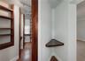 Record room or library with built-in wooden shelves & two built-in desks.