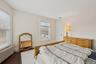 Bedroom featuring radiator heating unit and wood finished floors