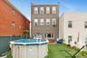 Rear view of house with a yard and a fenced in pool