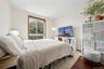Bedroom with wood finished floors and baseboards
