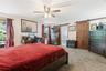 Spacious room featuring neutral carpeting and a ceiling fan