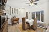 Dining area featuring a baseboard radiator, light wood-type flooring, and a ceiling fan