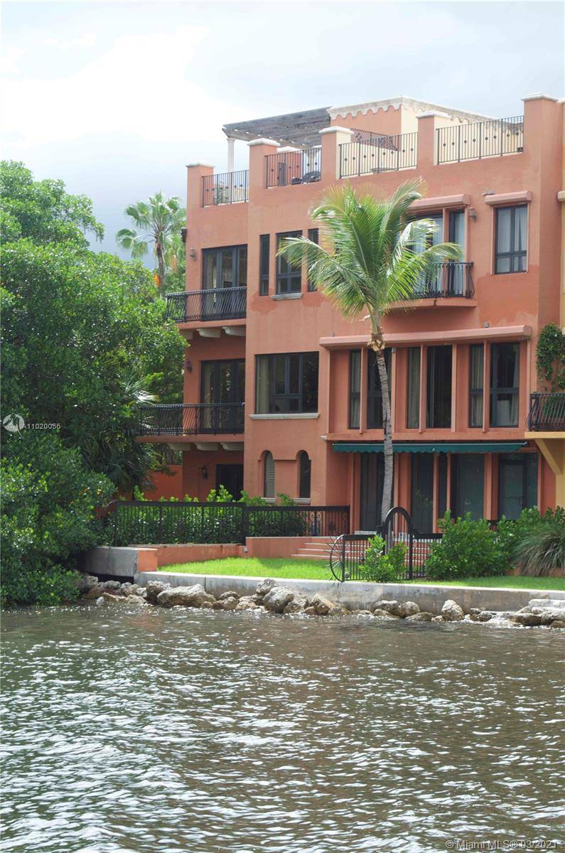 Gated Townhouse community on the water with guard house, 4 bedroom 4 1 2 bath, 5200 sqft, waterfront unit, grass yard, 2 car garage w Tesla charging plus covered carport ...