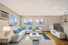 Living room with light wood finished floors, recessed lighting, a baseboard heating unit, a chandelier, and a wall mounted air conditioner