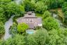 An aerial perspective showcases the home's distinctive contemporary architecture, resort-inspired amenities, and extraordinary two-acre setting.
