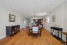 Open-concept dining area featuring wood-finish flooring, recessed lighting, and a chandelier