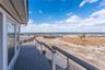 Balcony with a view of the beach and a water view