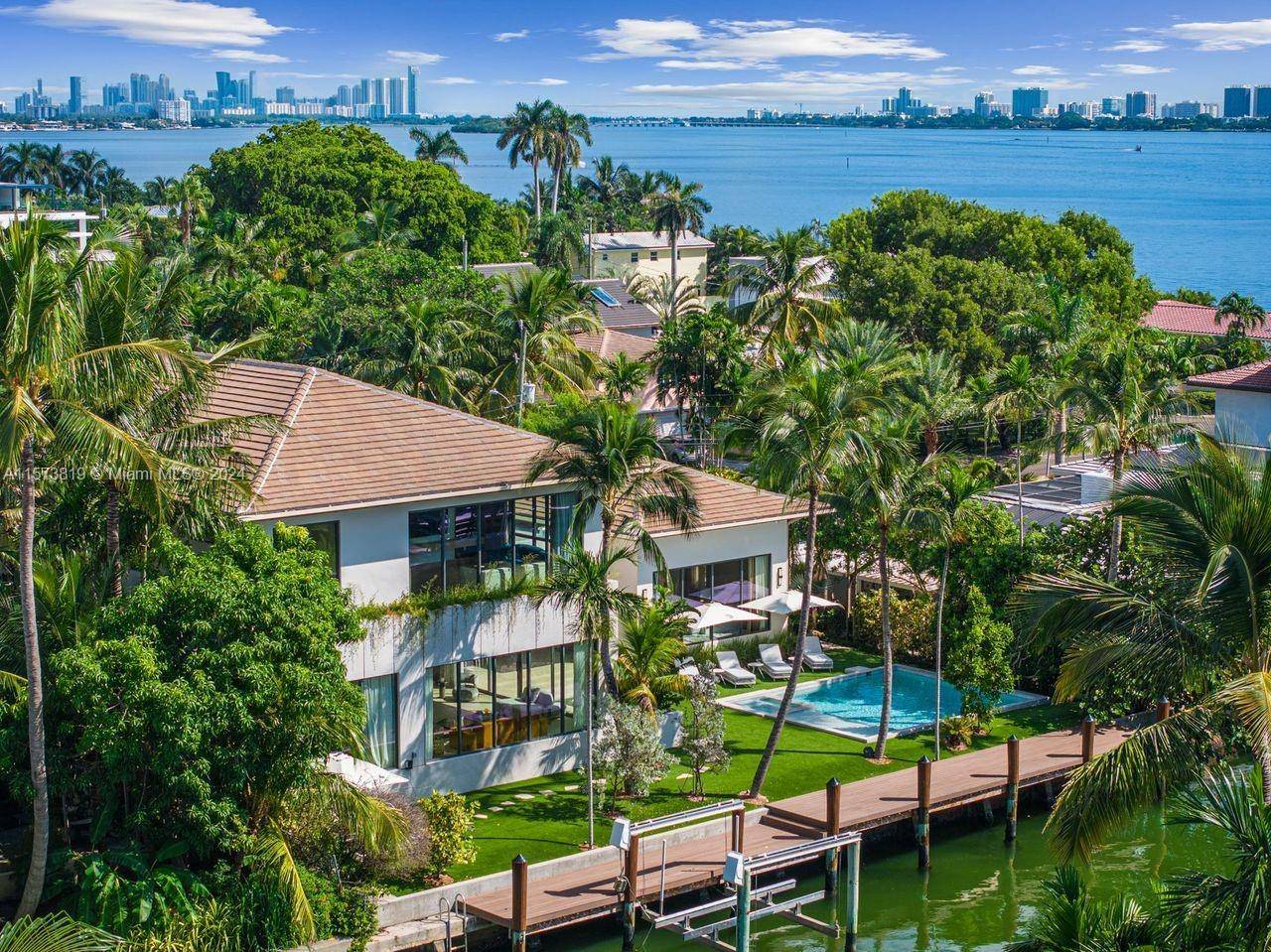 This waterfront new construction home is a masterpiece of tropical modernism.