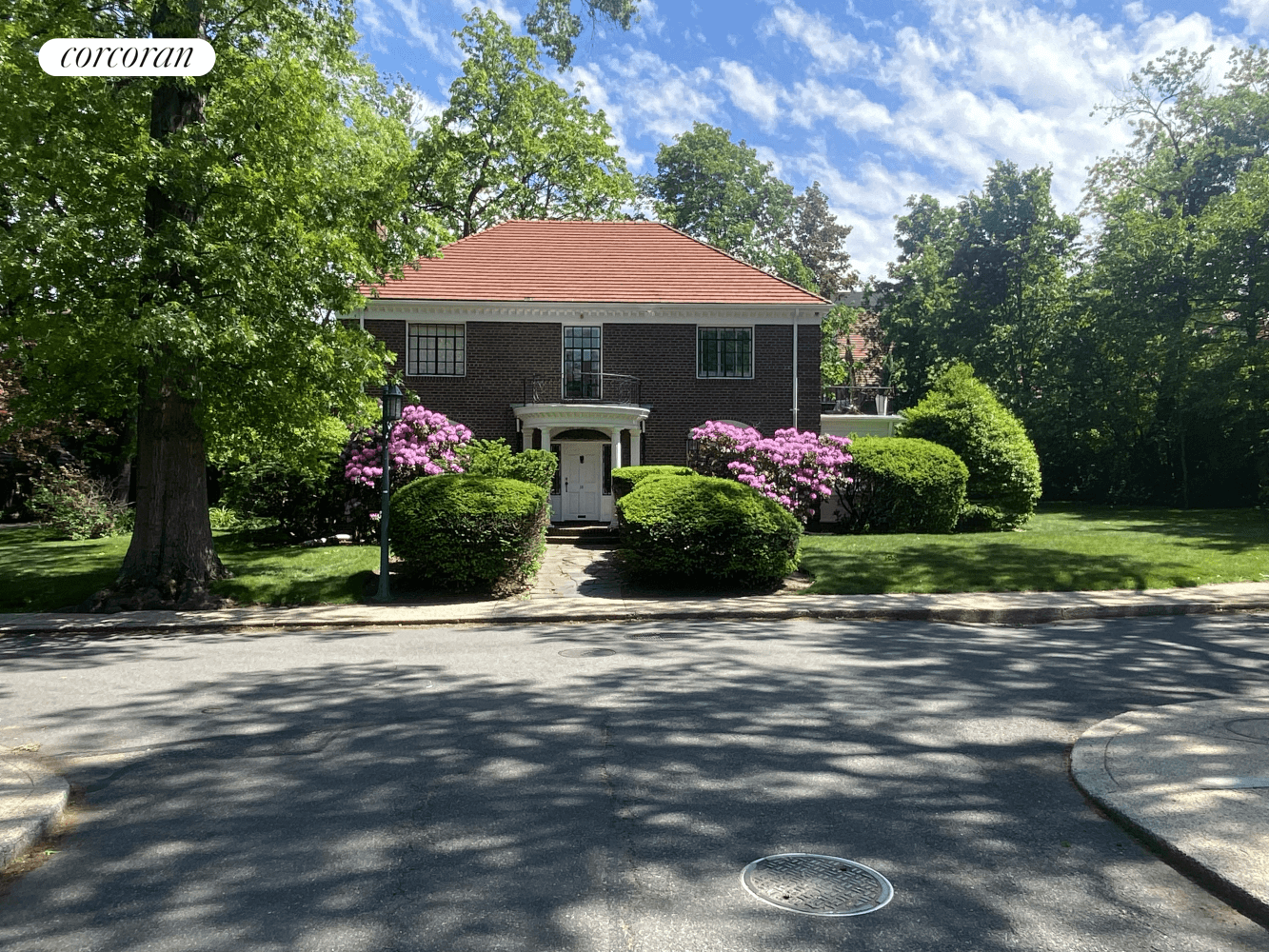 Imagine residing in a distinguished, freestanding Federalist brick home, a true landmark majestically set atop a hill on a tranquil side street within the coveted Forest Hills Gardens.