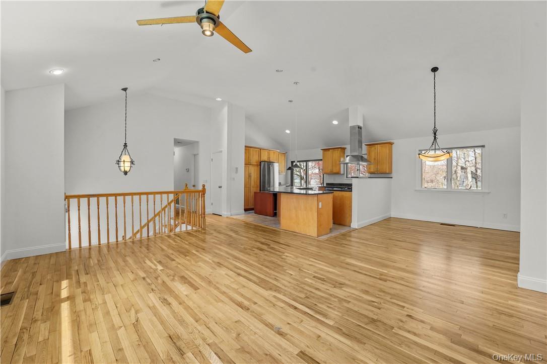 View of Living Room, Dining Room and Kitchen. Hard wood floors have been polished and wall freshly painted.