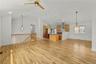 View of Living Room, Dining Room and Kitchen. Hard wood floors have been polished and wall freshly painted.