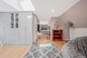Bedroom with lofted ceiling, a skylight, light wood-style flooring, and recessed lighting