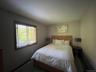 Bedroom featuring dark carpet