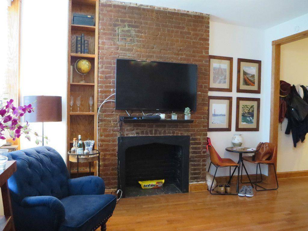 Beautiful and quiet one bedroom with decorative fireplace and exposed brick.