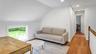 Living room with vaulted ceiling and light wood-type flooring