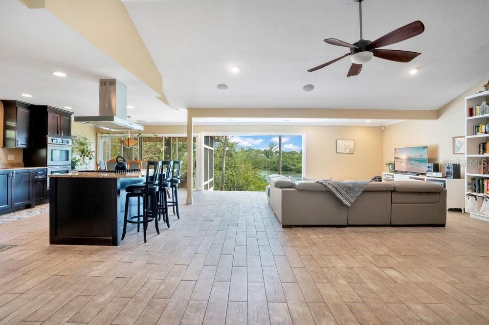 Open kitchen/living area with vaulted ceilings and an abundance of natural light