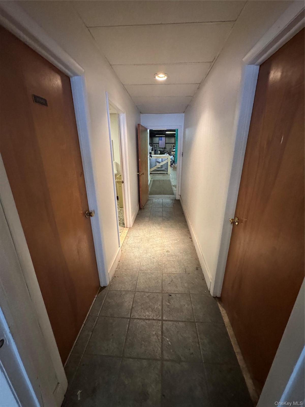 Hall with recessed lighting and baseboards