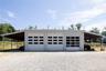 Exterior view of large garage structure with three 14' run-ins