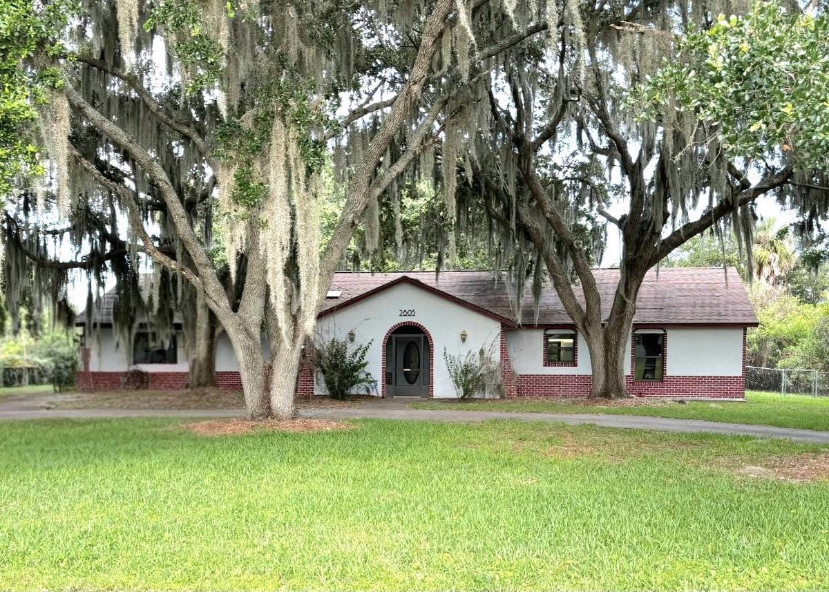Front of home with circular driveway.