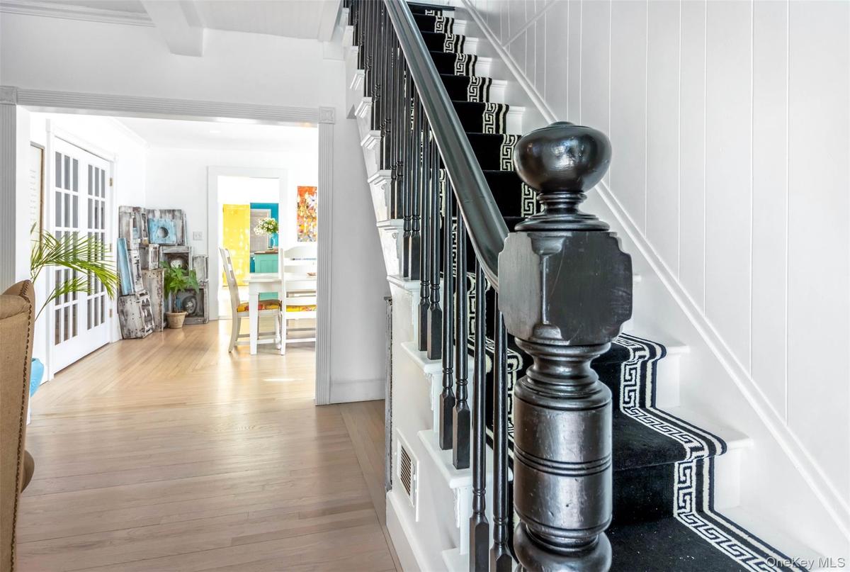 Staircase featuring wood finished floors