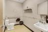Half bathroom with light flooring and a paneled ceiling