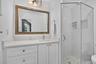 PRIMARY ENSUITE BATHROOM, Newly installed vanity with tons of storage spaces, brightly tiled and has a sunny east window too!