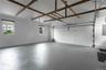 Garage featuring electric panel and a garage door opener