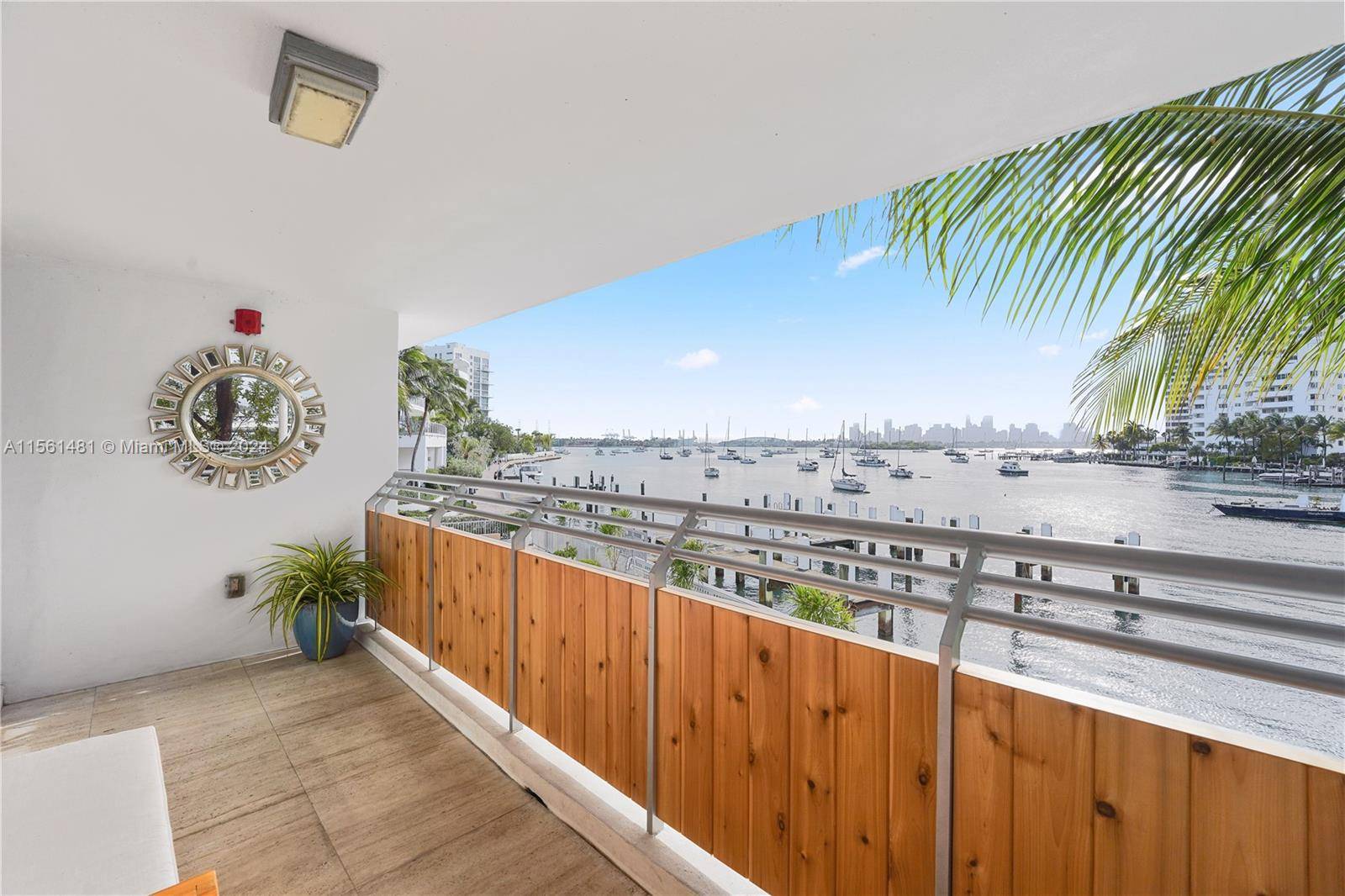 Luxury bayfront corner unit, remodeled and fully furnished, featuring a large covered terrace overlooking the bay and panoramic views of the Miami skyline and sunsets.