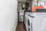 Utility area featuring a side-by-side washer and dryer, water heater, and exposed plumbing