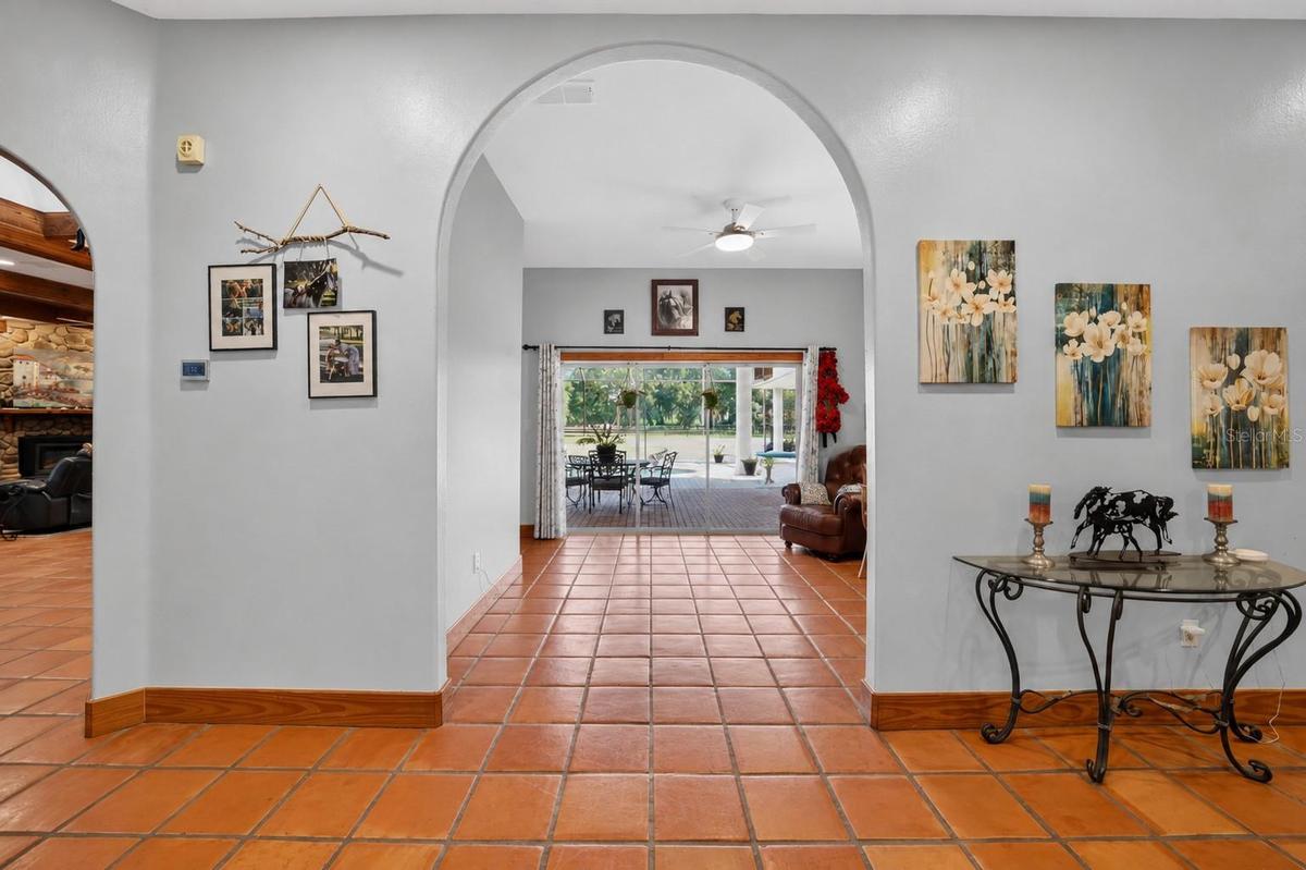 Grand Foyer with Ceramic Floors Throughout and Views Through the Living Room to the Swimming Pool