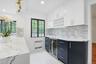 An elegant extension of the kitchen, the butler's pantry offers built-in wine storage, a wine refrigerator, and additional preparation and serving spa