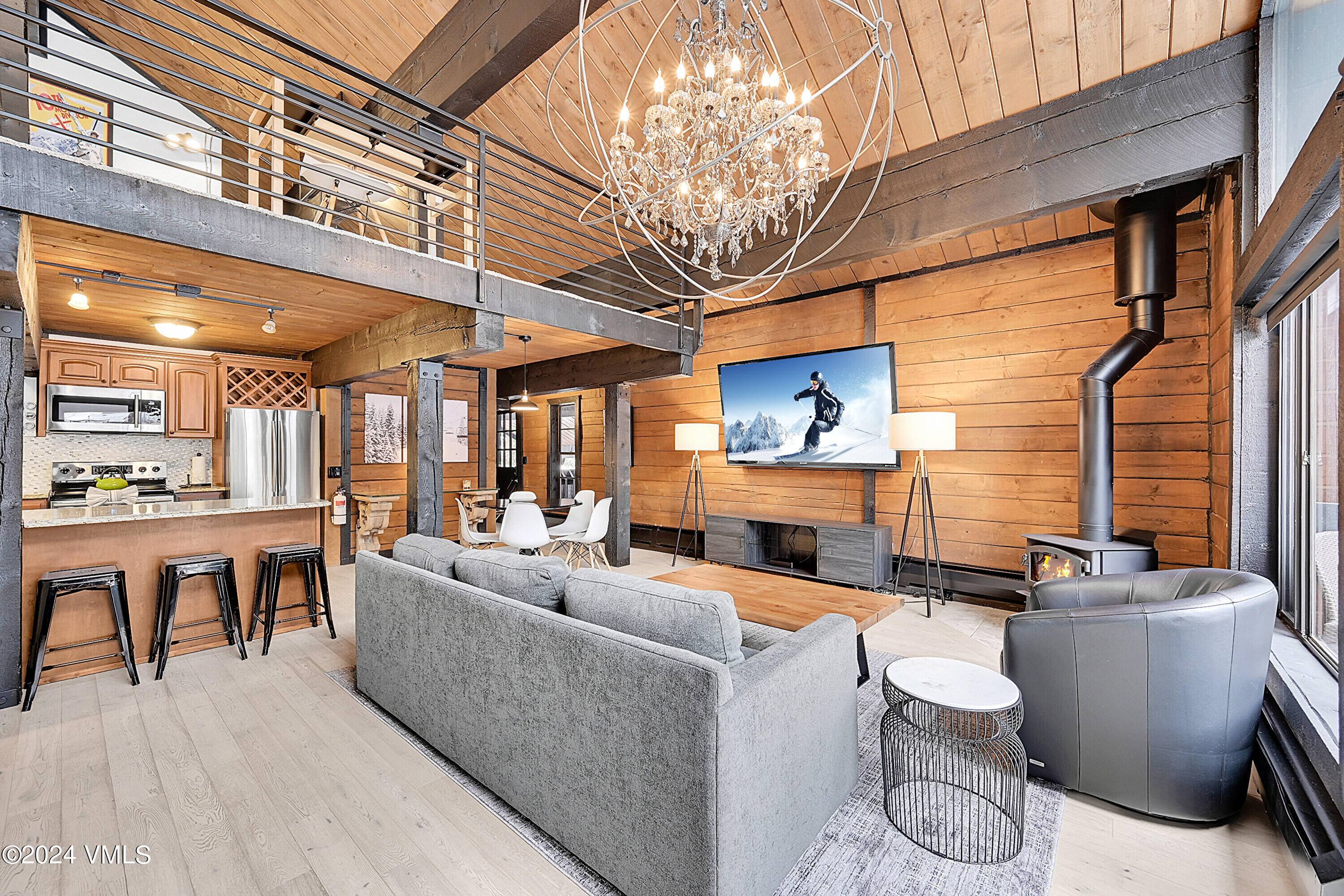 Bright penthouse on Gore Creek with vaulted ceilings, skylights, fun sized kitchen, bar top, dining area, loft office sleeping area, wood stove, huge TV and a massive wall of glass ...
