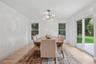 Dining room with baseboards, an inviting chandelier, and light wood-style flooring