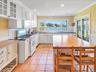 backsplash, and light tile patterned floors